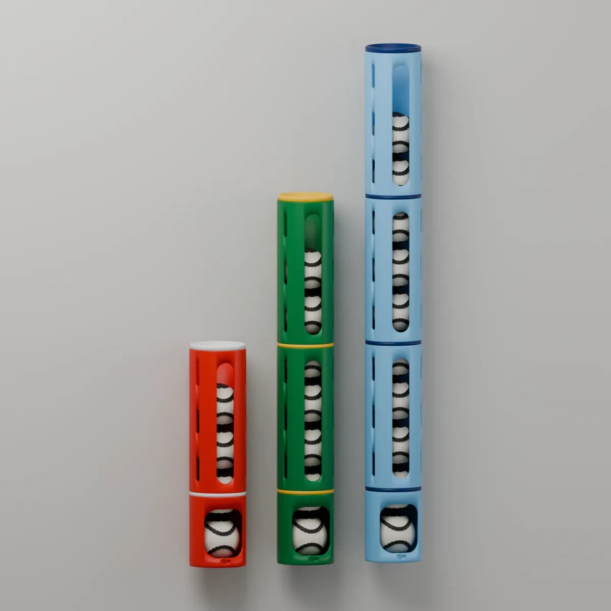 The three sizes of the sliotar dispenser side by side on a wall: 4 sliotars in red and white, 7 in green and gold, 10 in sky blue and navy