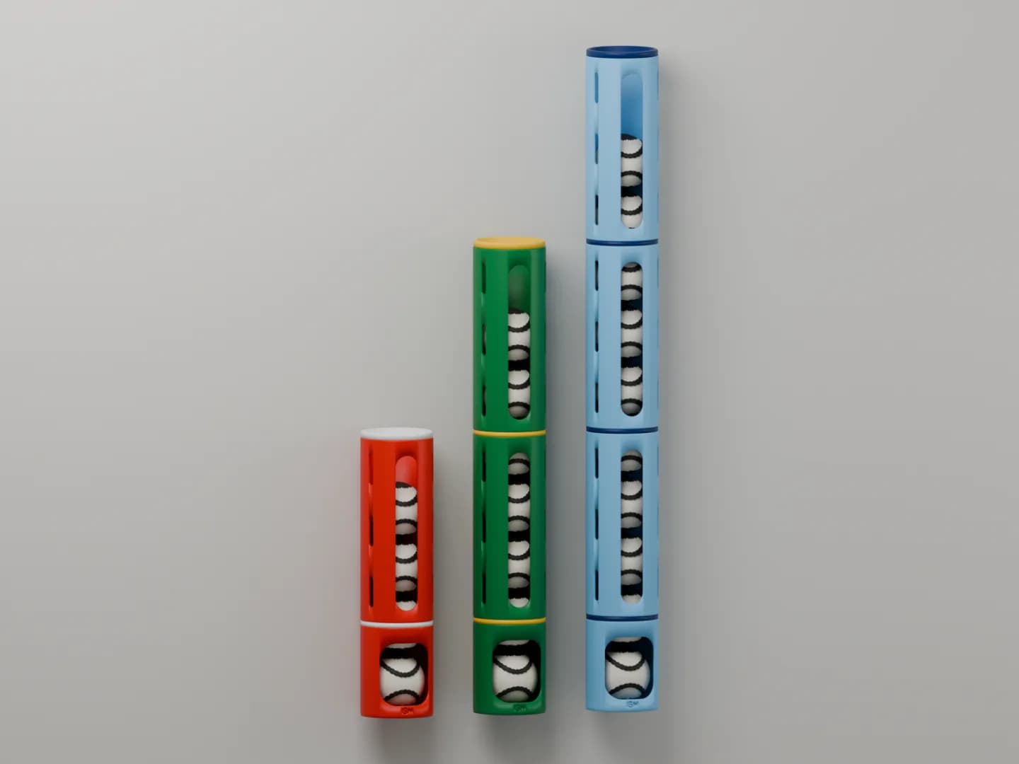 Three sliotar dispensers on a wall, for 4, 7 and 10 sliotars, in red and white, green and gold, and sky blue and navy